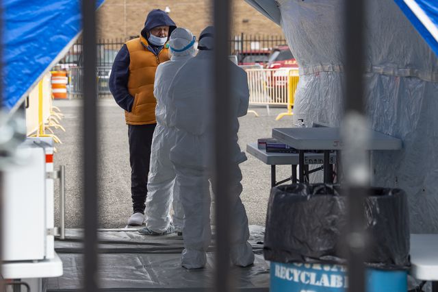 A man is tested by a doctor in protective gear at The Covid-19 testing site on Marin Boulevard in Jersey City, New Jersey.